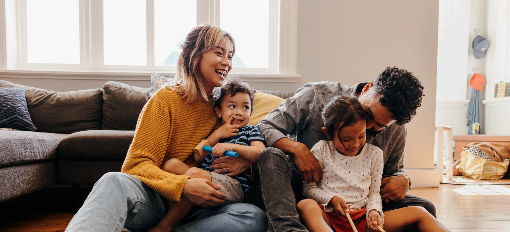 parents with two young kids playing on the floor
