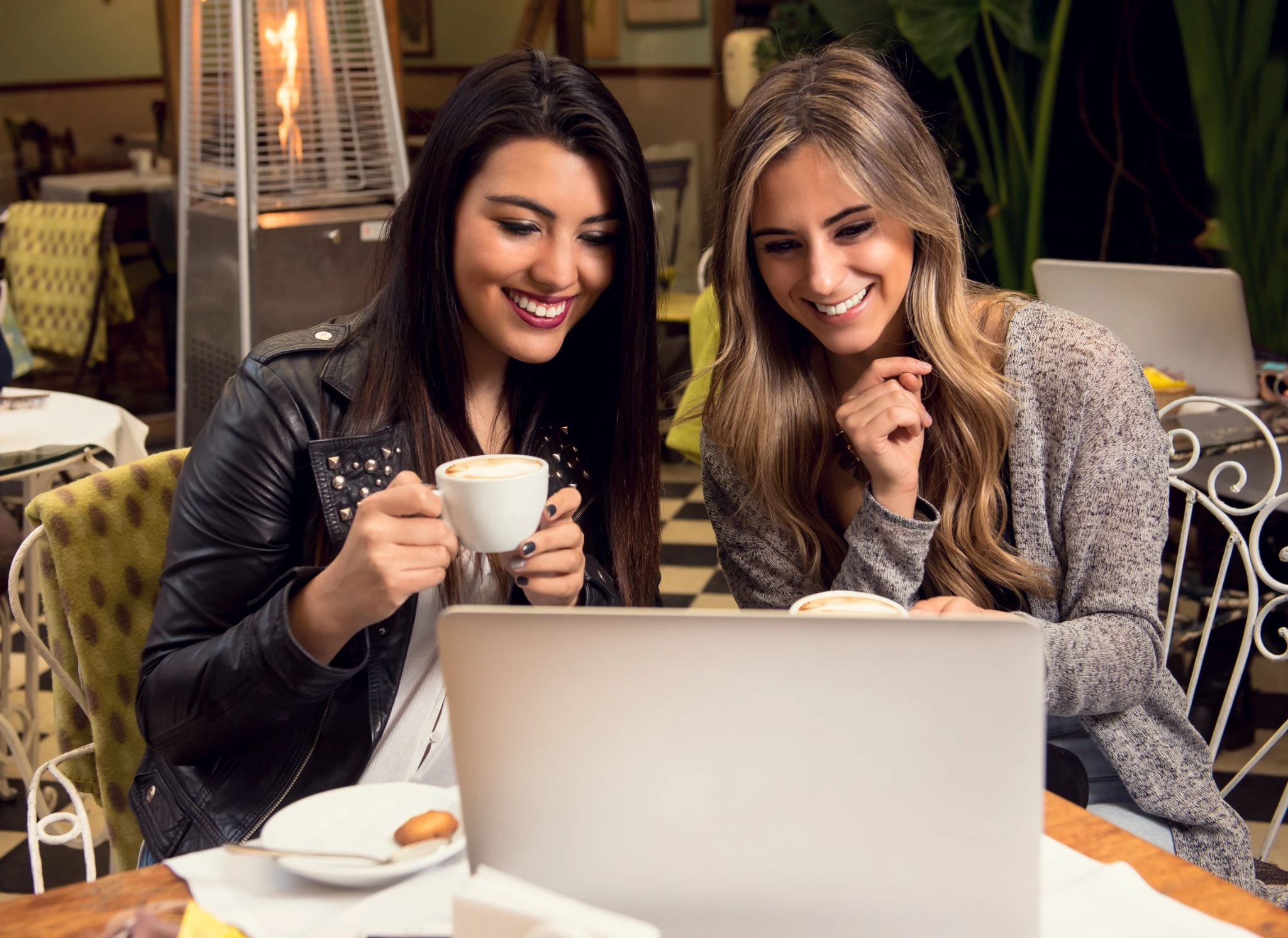 Two girlfriends sharing information while having a coffee.