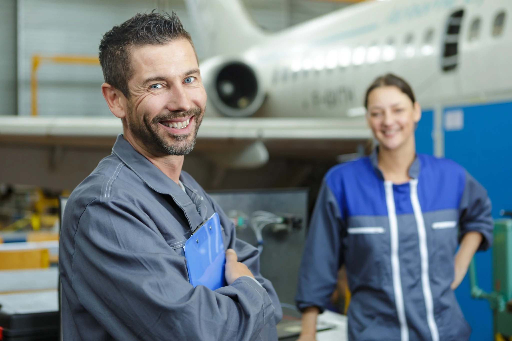 engineers and technicians repairing aircraft.