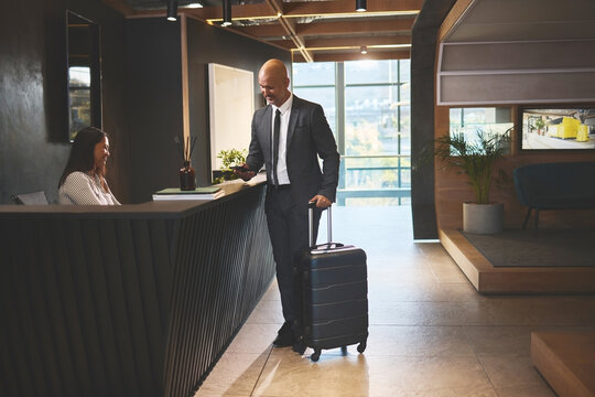 Man with luggage checking into hotel
