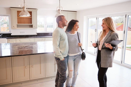 Couple with realtor in kitchen