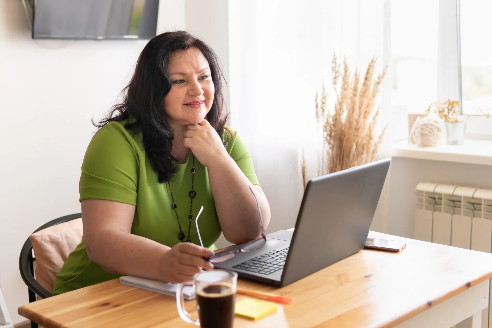 Woman on computer at home desk