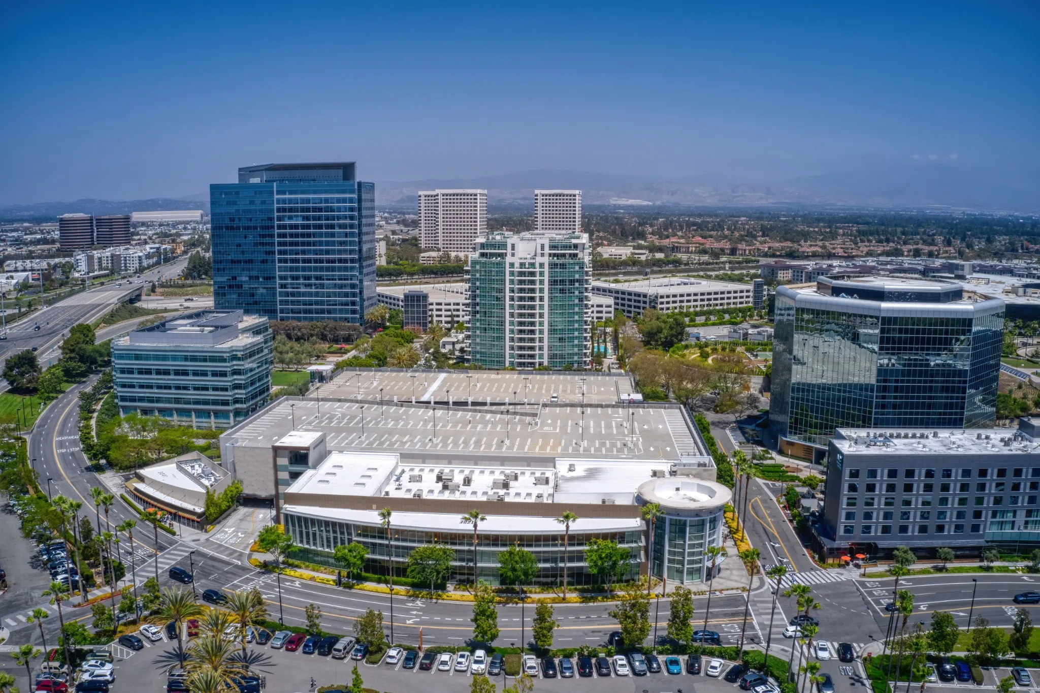 Young woman with pink hair playing video game on a Gaming convention.