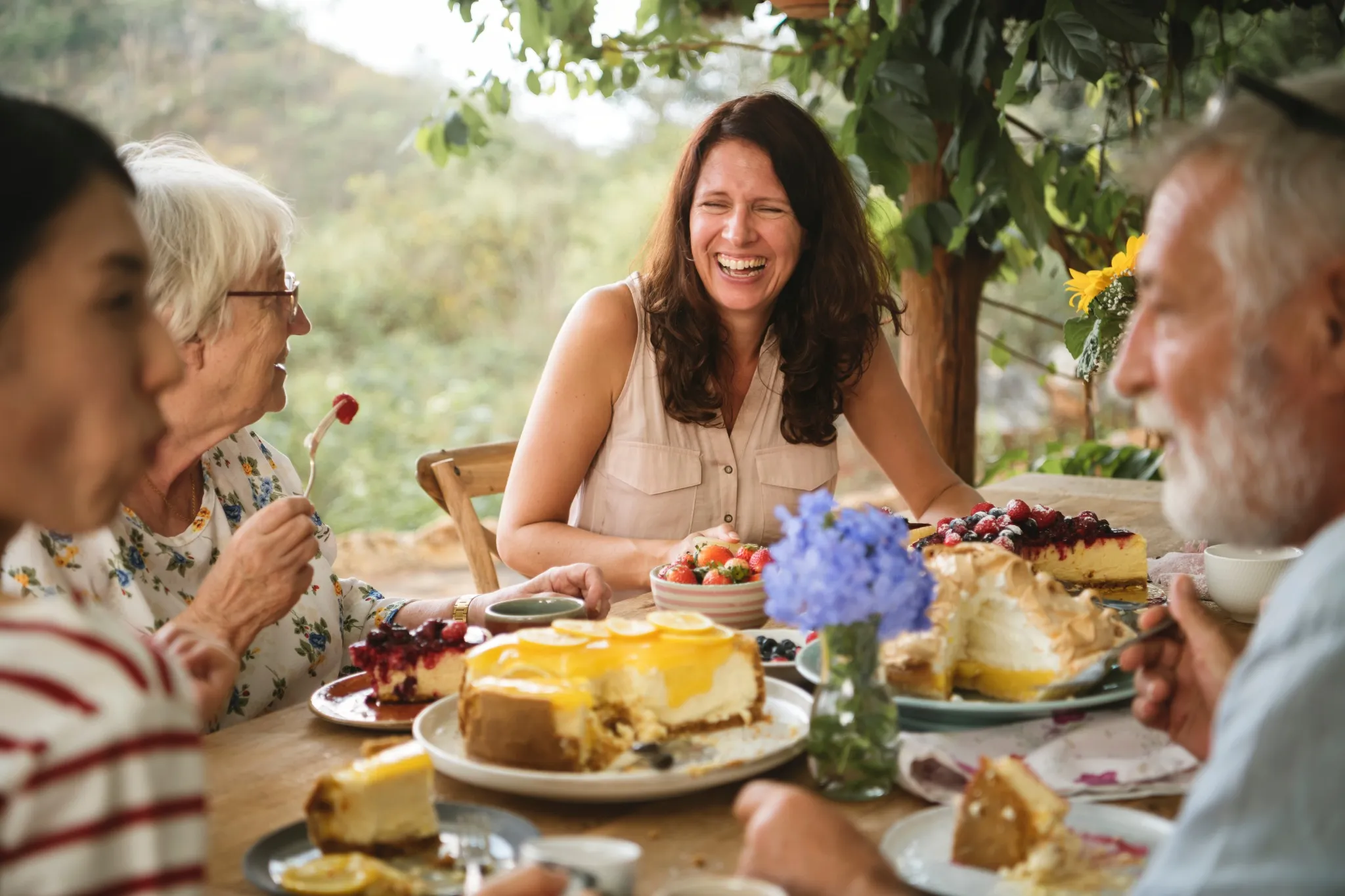 Friends enjoying dessert in the garden.