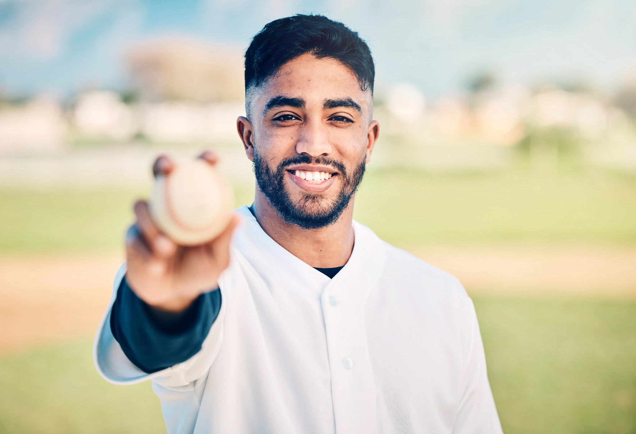 man holding a baseball in front of him
