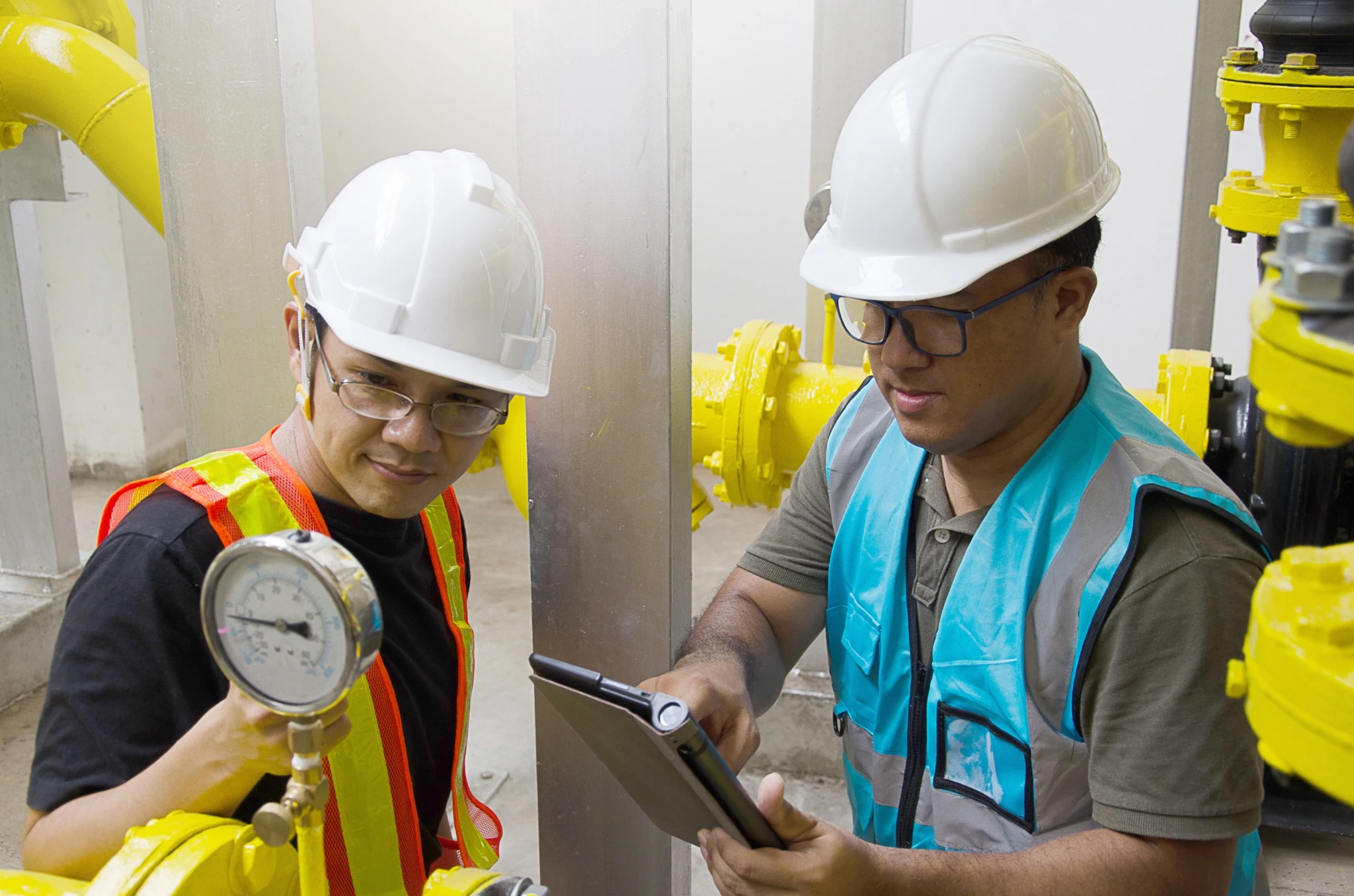 Senior engineer and technician Asians is checking the answers of cooling system for the safety of the system.