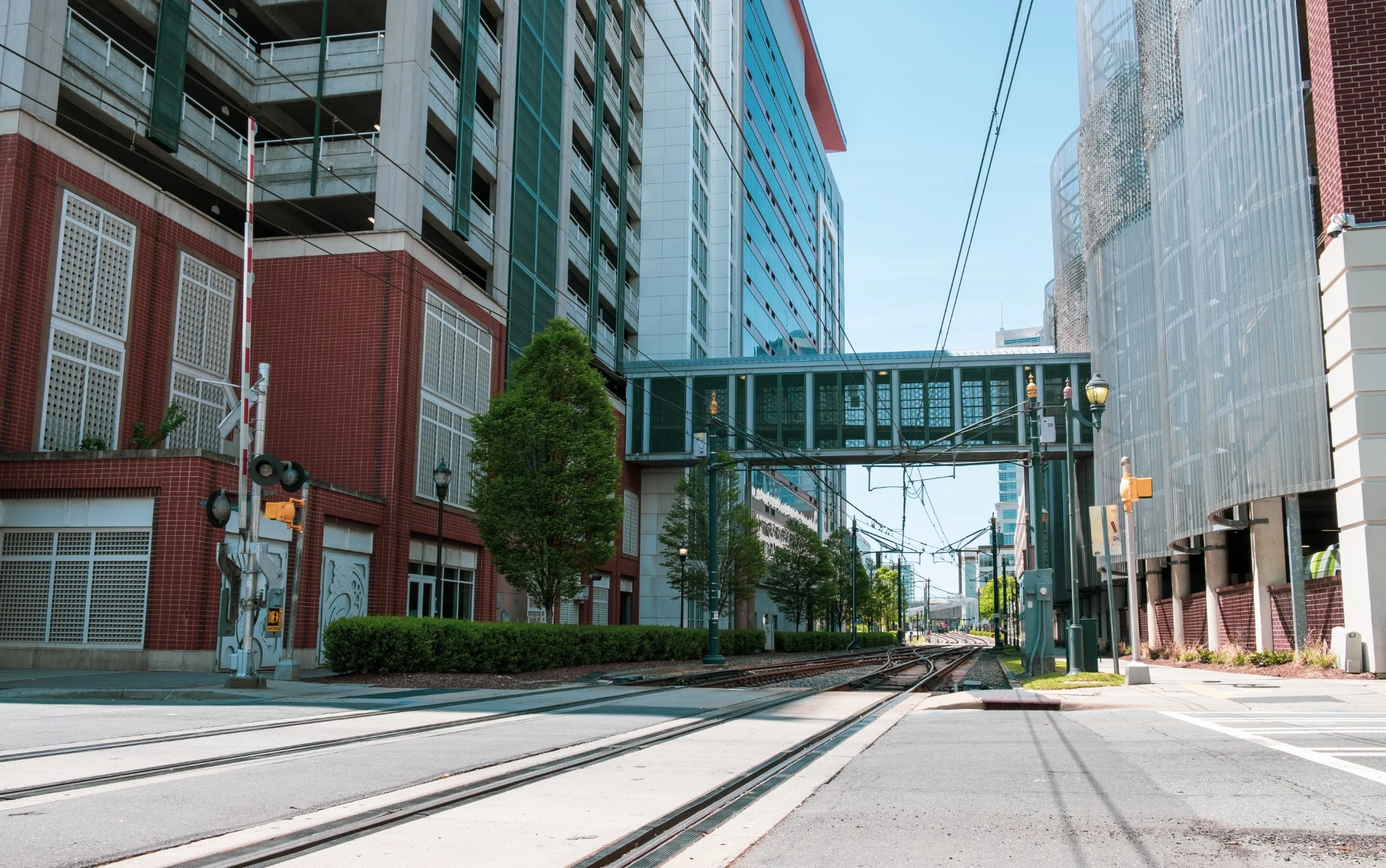 Skybridge between two tall buildings over light rail track in downtown Charlotte