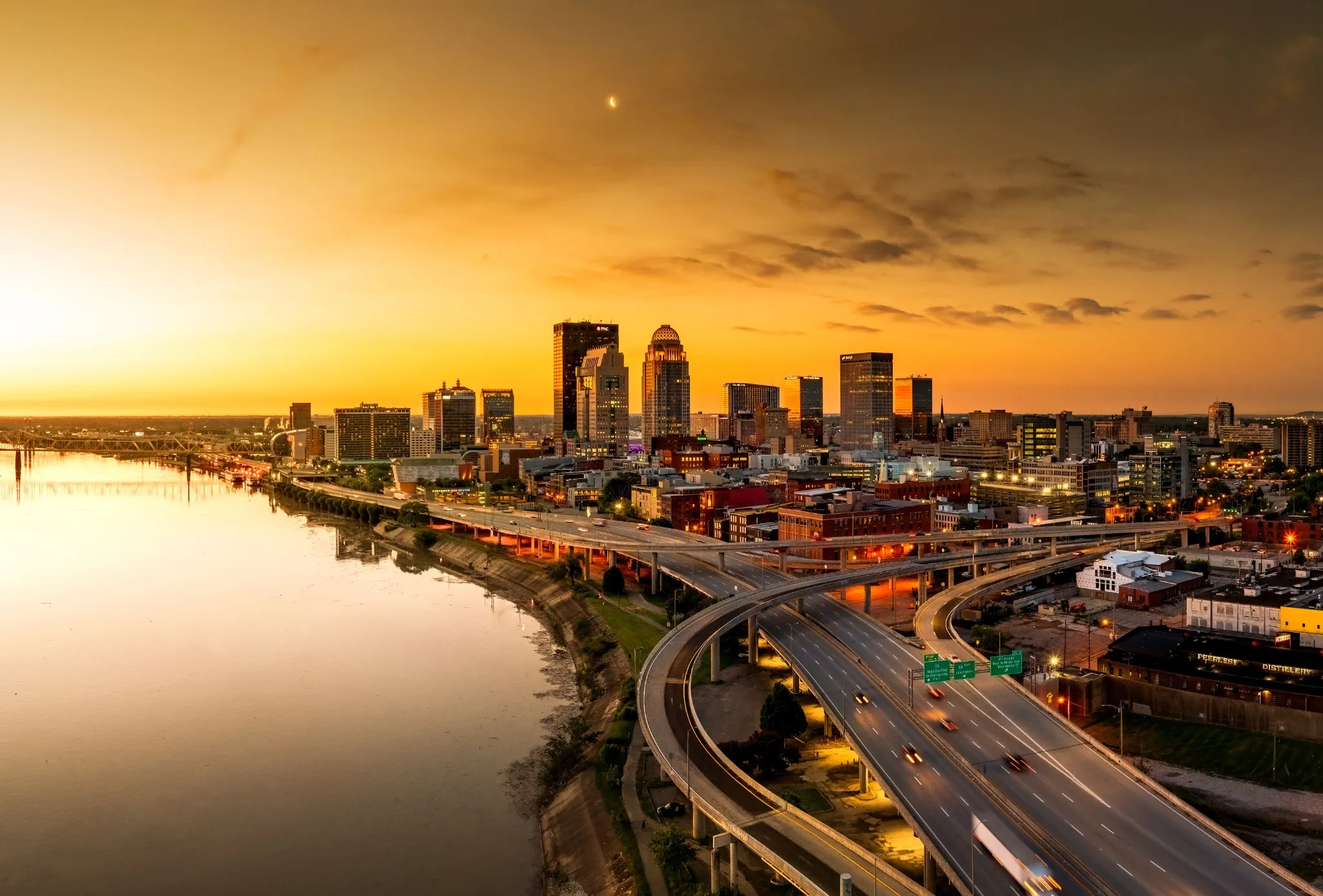 Aerial shot of the Louisville, KY bridge with the Ohio River at sunrise