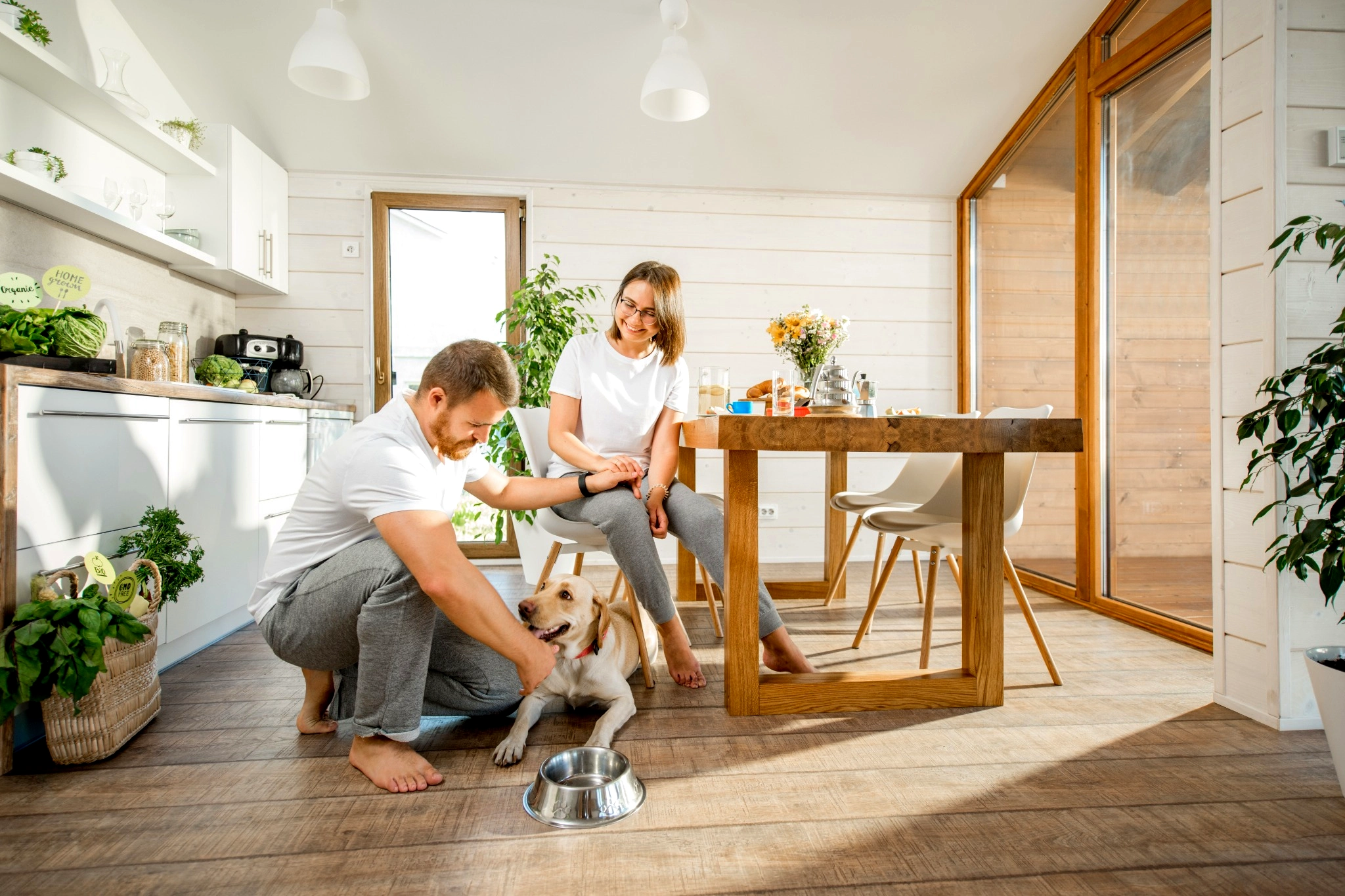 Couple in their dining room with their yellow lab