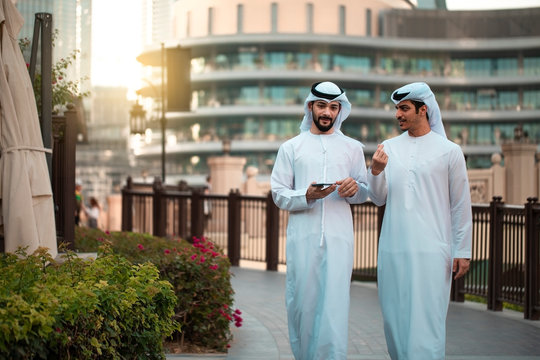 Two men walking around Dubai