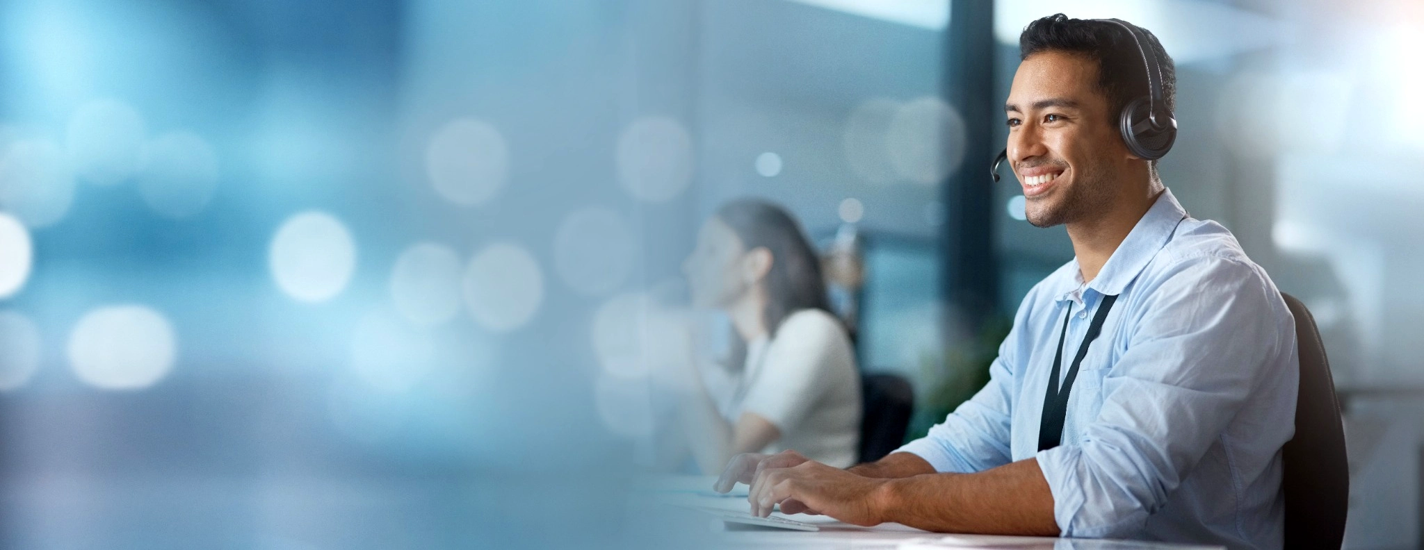 Man with a headset smiling 