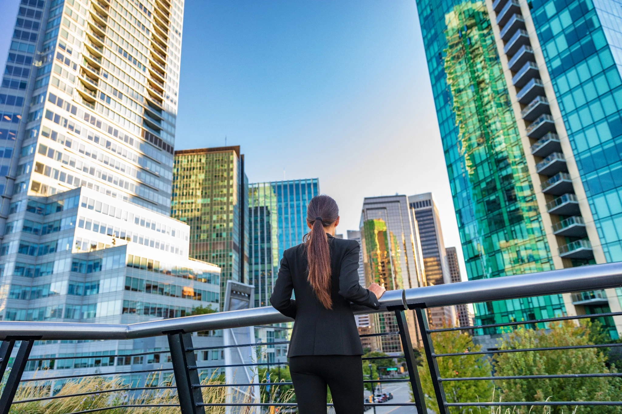Business woman looking into the city center skyline
