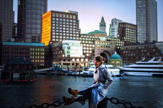 Girl in the day in front of the cityscape and yachts