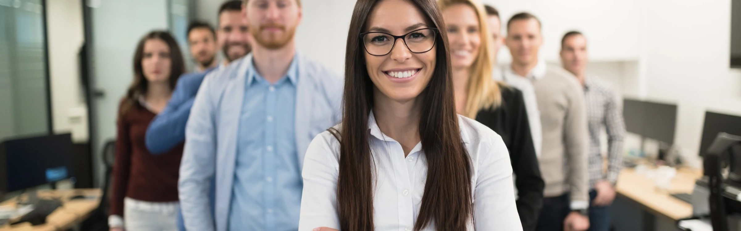 Young leaders in workforce standing in group, ready to learn
