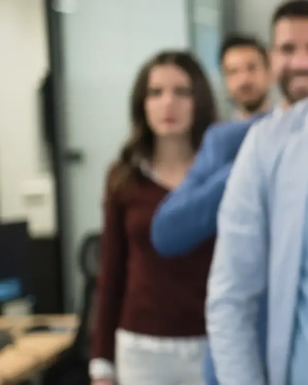Young leaders in workforce standing in group, ready to learn