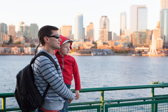 Father holding young son overlooking Seattle, WA