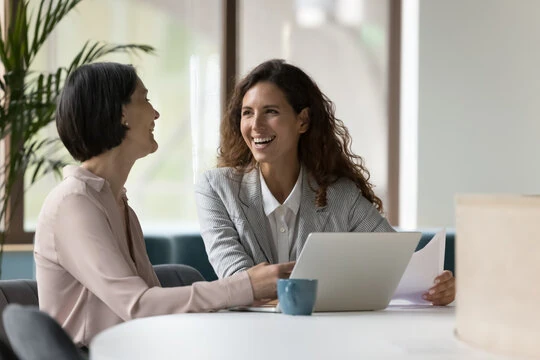 Two woman happily working together