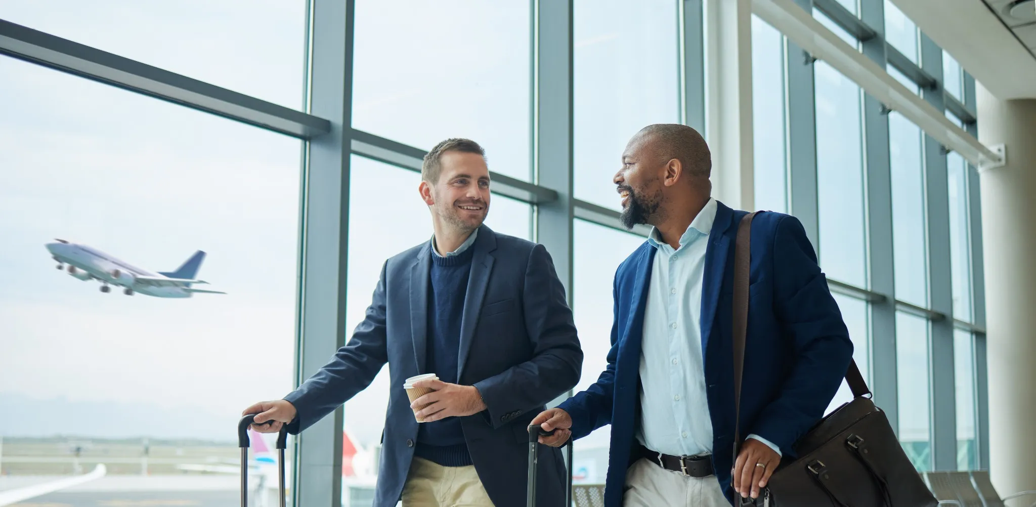 Two business men with roller bags at airport