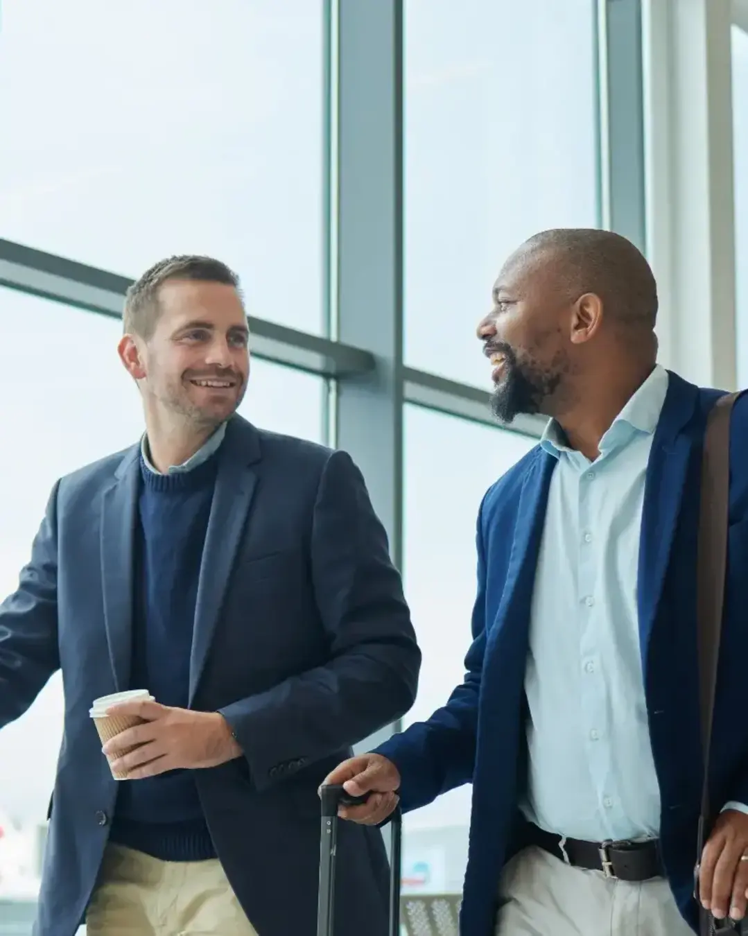 Two business men with roller bags at airport