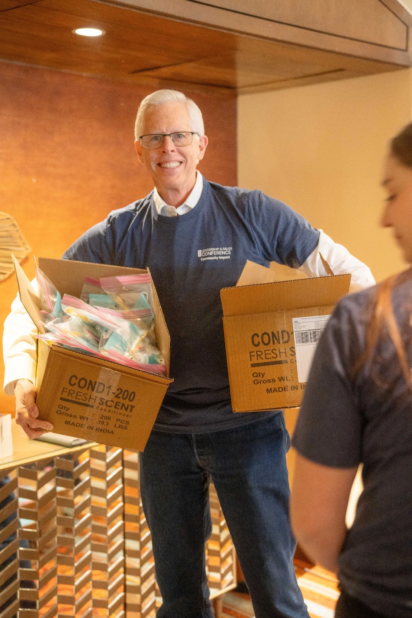 Tom (National Corporate Housing founder) carrying boxes at service event