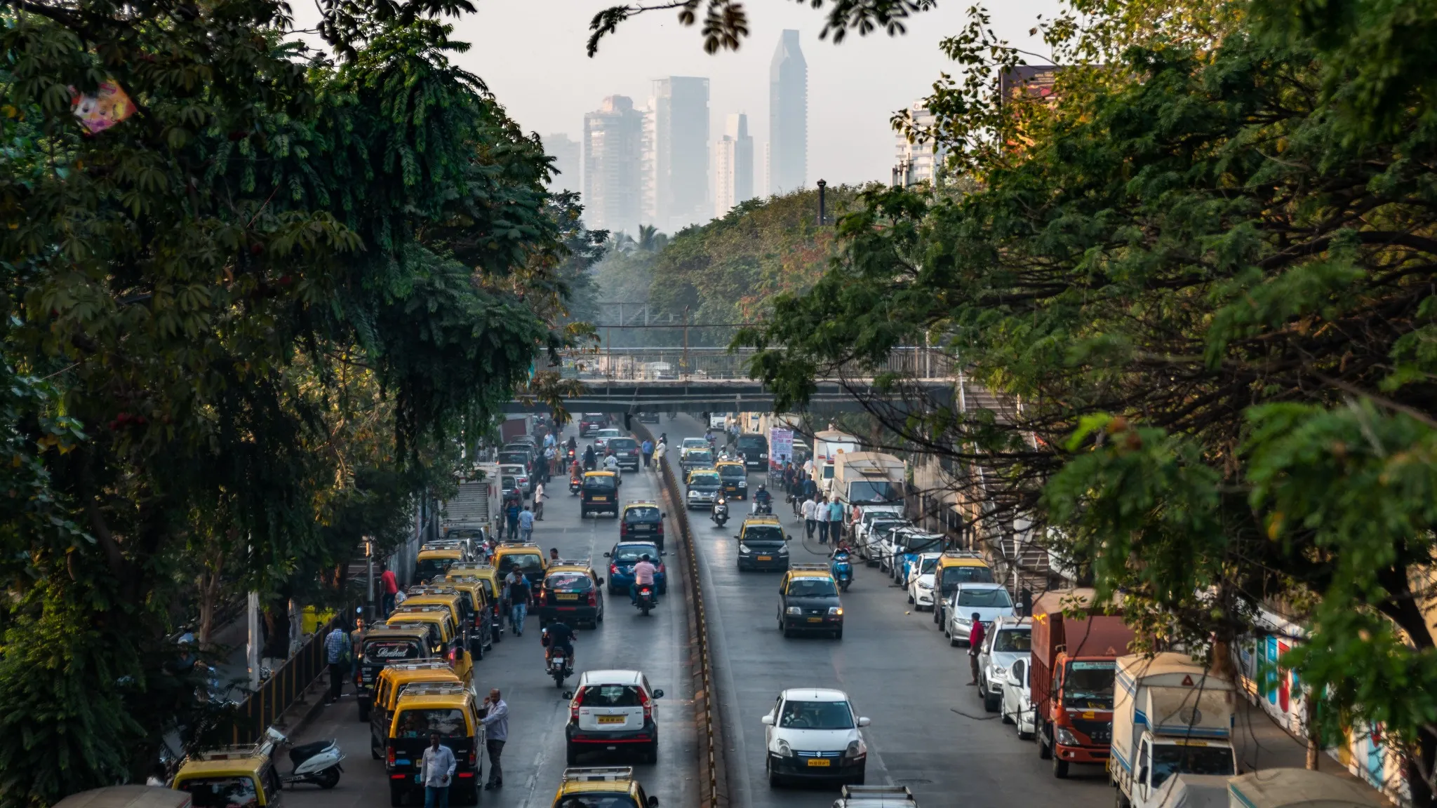 view from a bridge of a traffic city of bombay during a day.