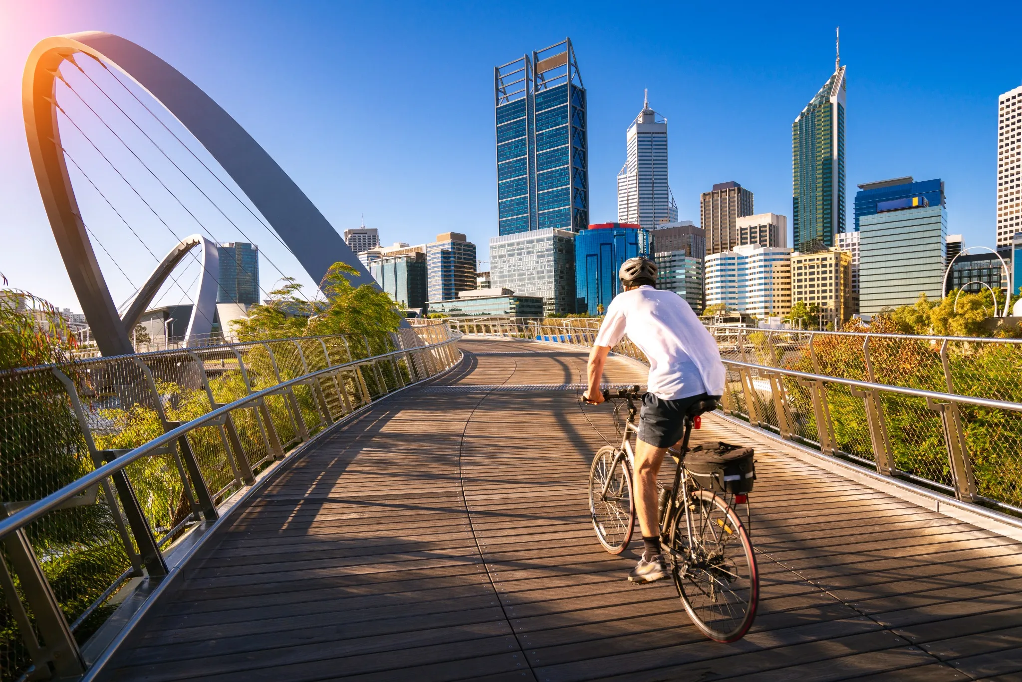 A man cycling on an elizabeth bridge in Perth city 