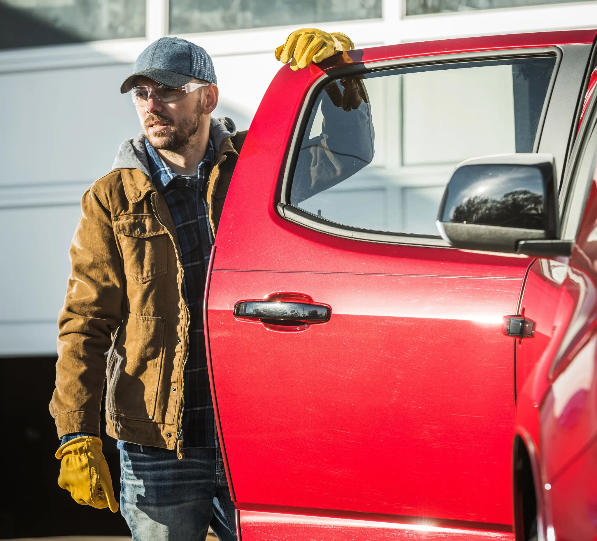 Construction worker getting out of pick-up