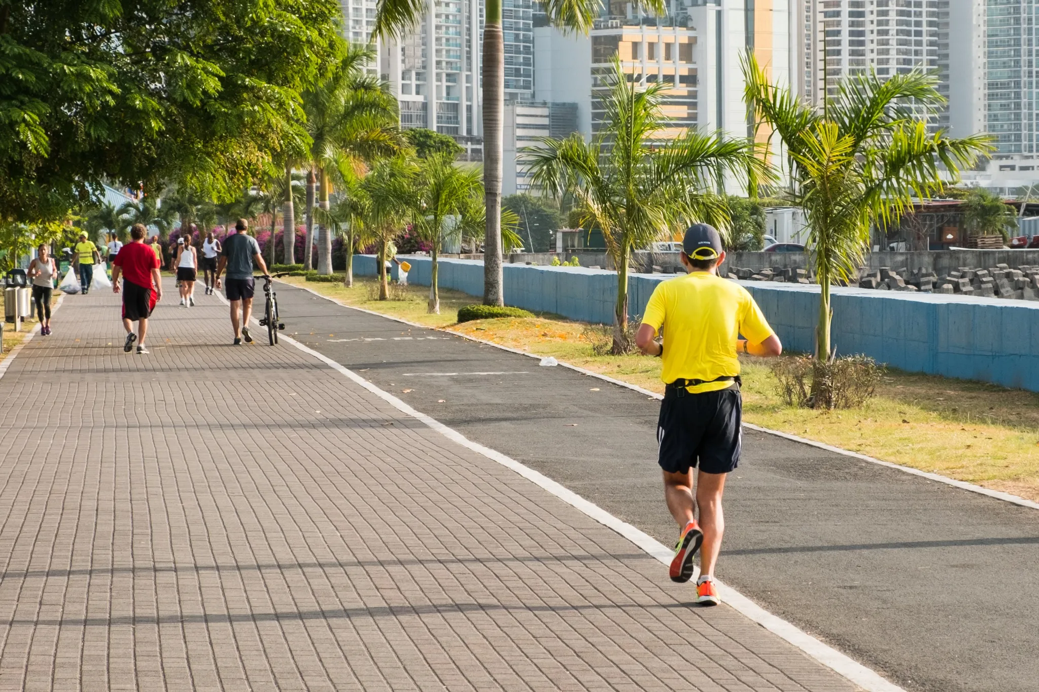 people running in public park with city background .
