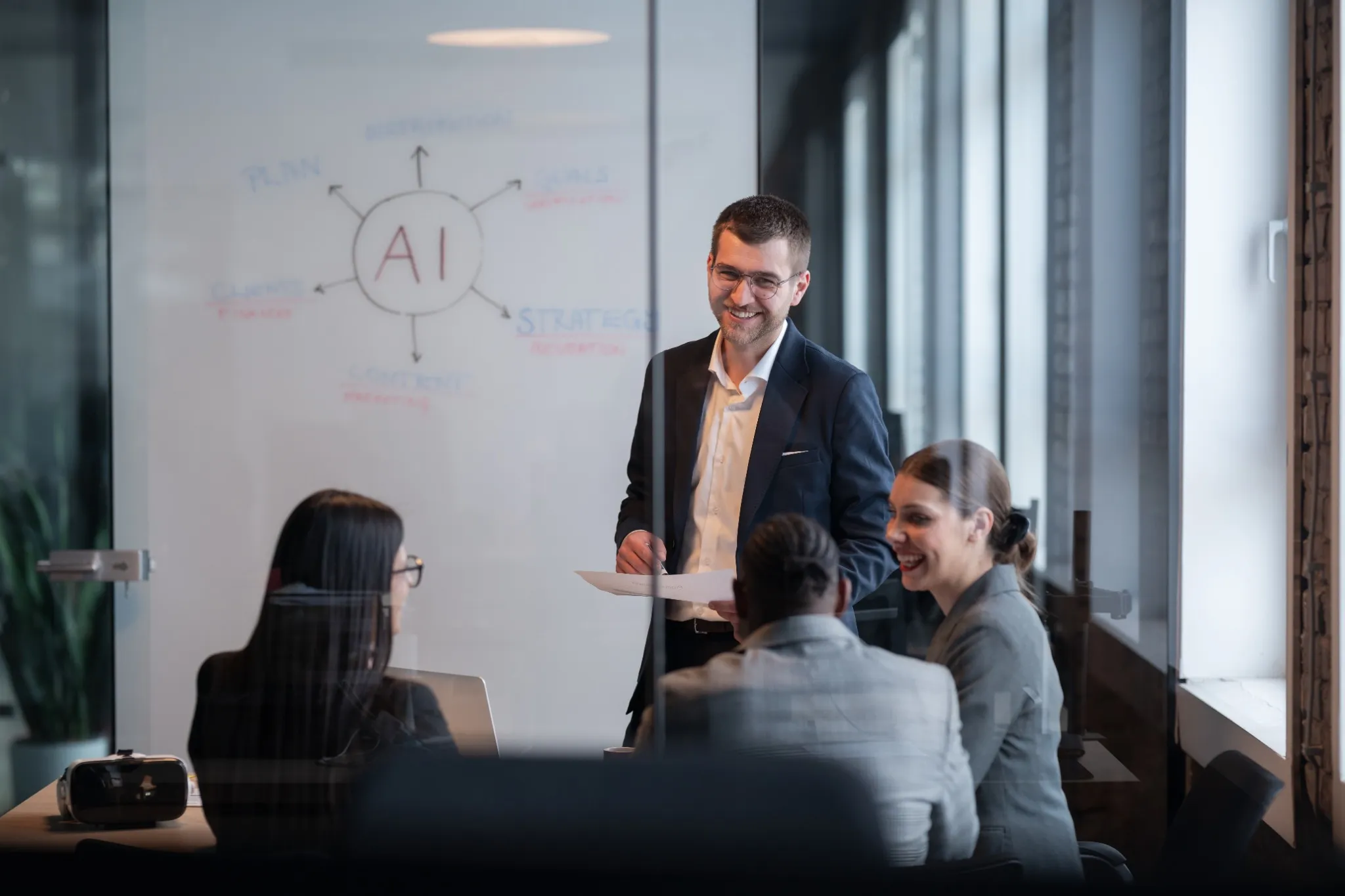 Diverse business team in a modern office during a meeting, discussing artificial intelligence strategy.