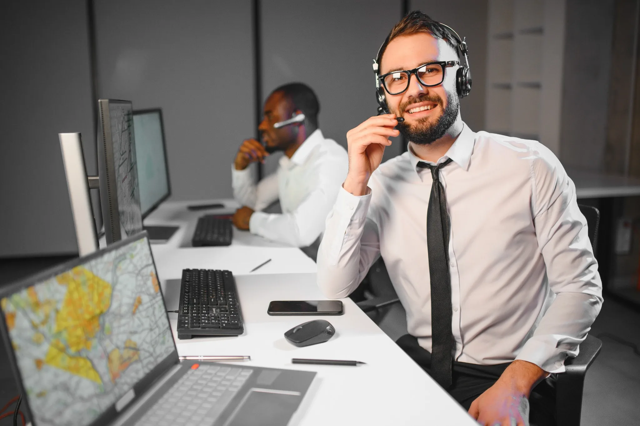 Smiling Secret service men in ties at computer