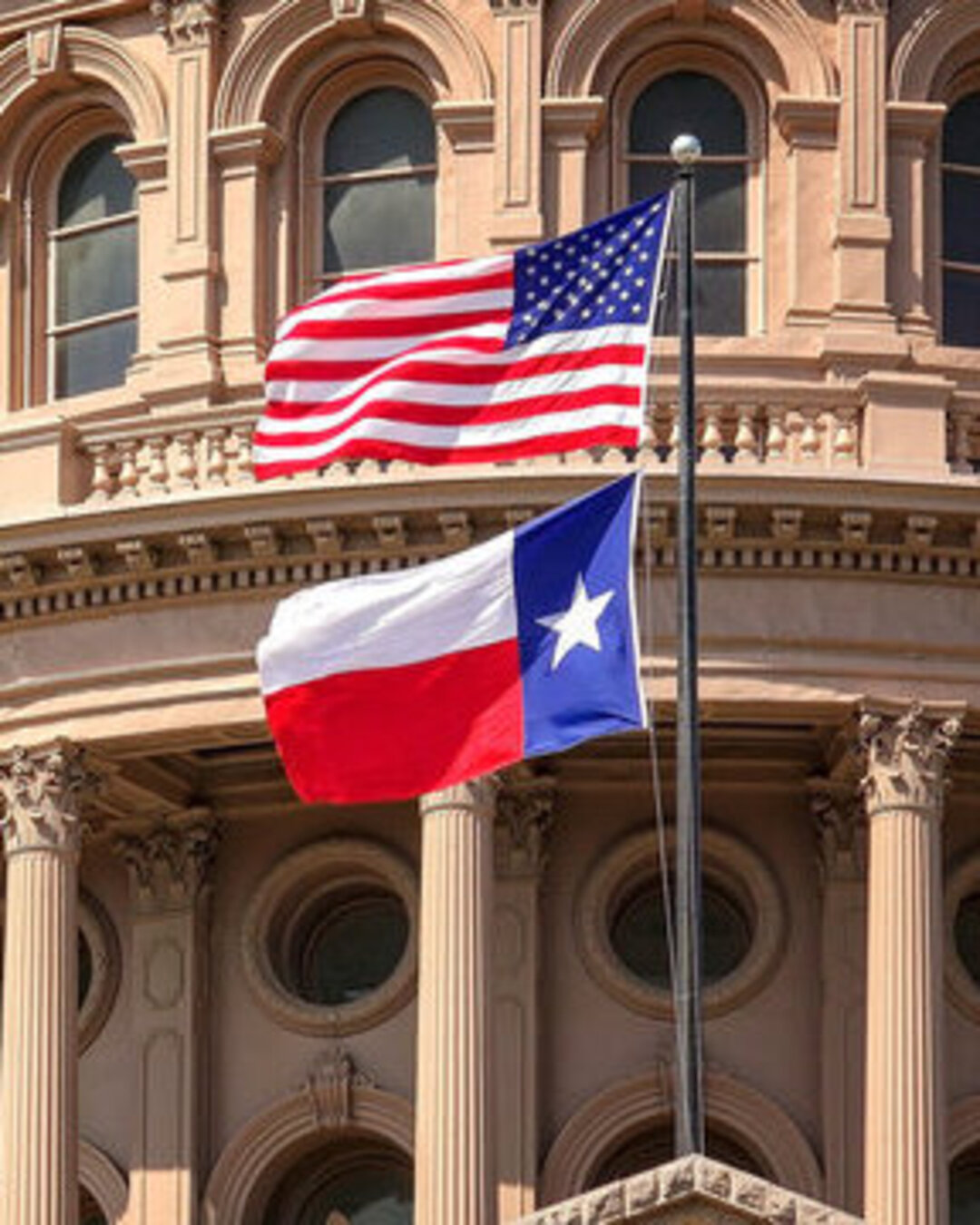American and Texas state flags flying 
