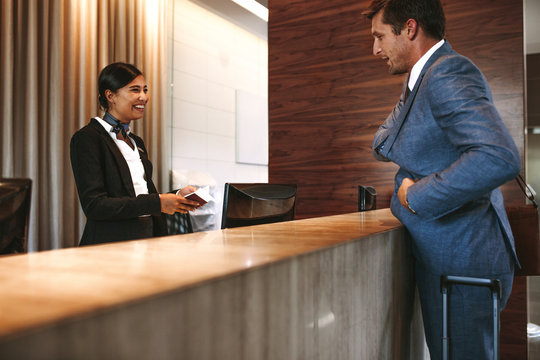 Professional man checking into a hotel