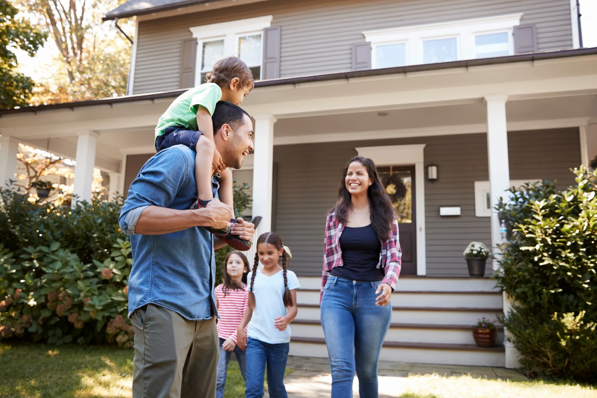 Candid happy family in front of home