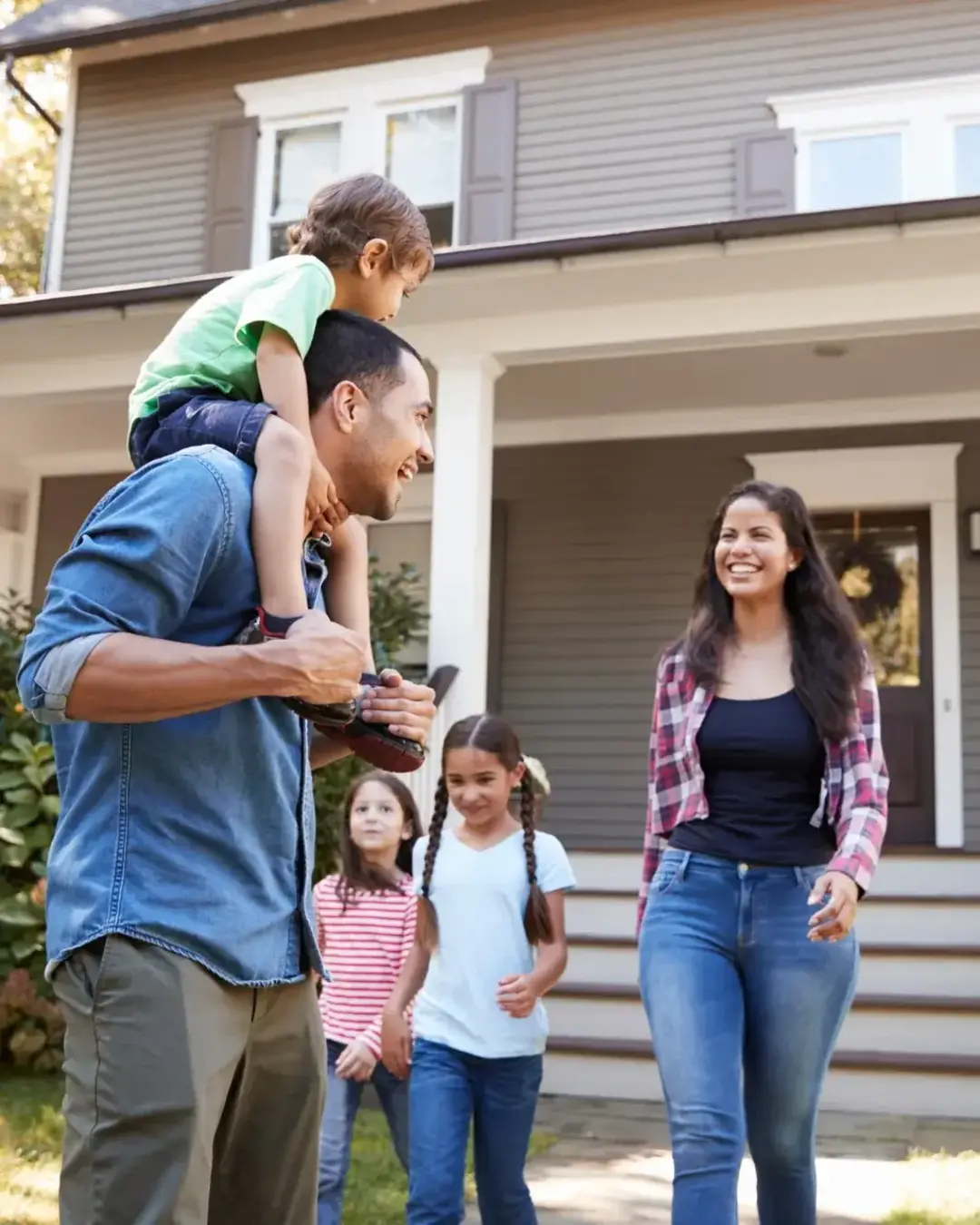 Candid happy family in front of home