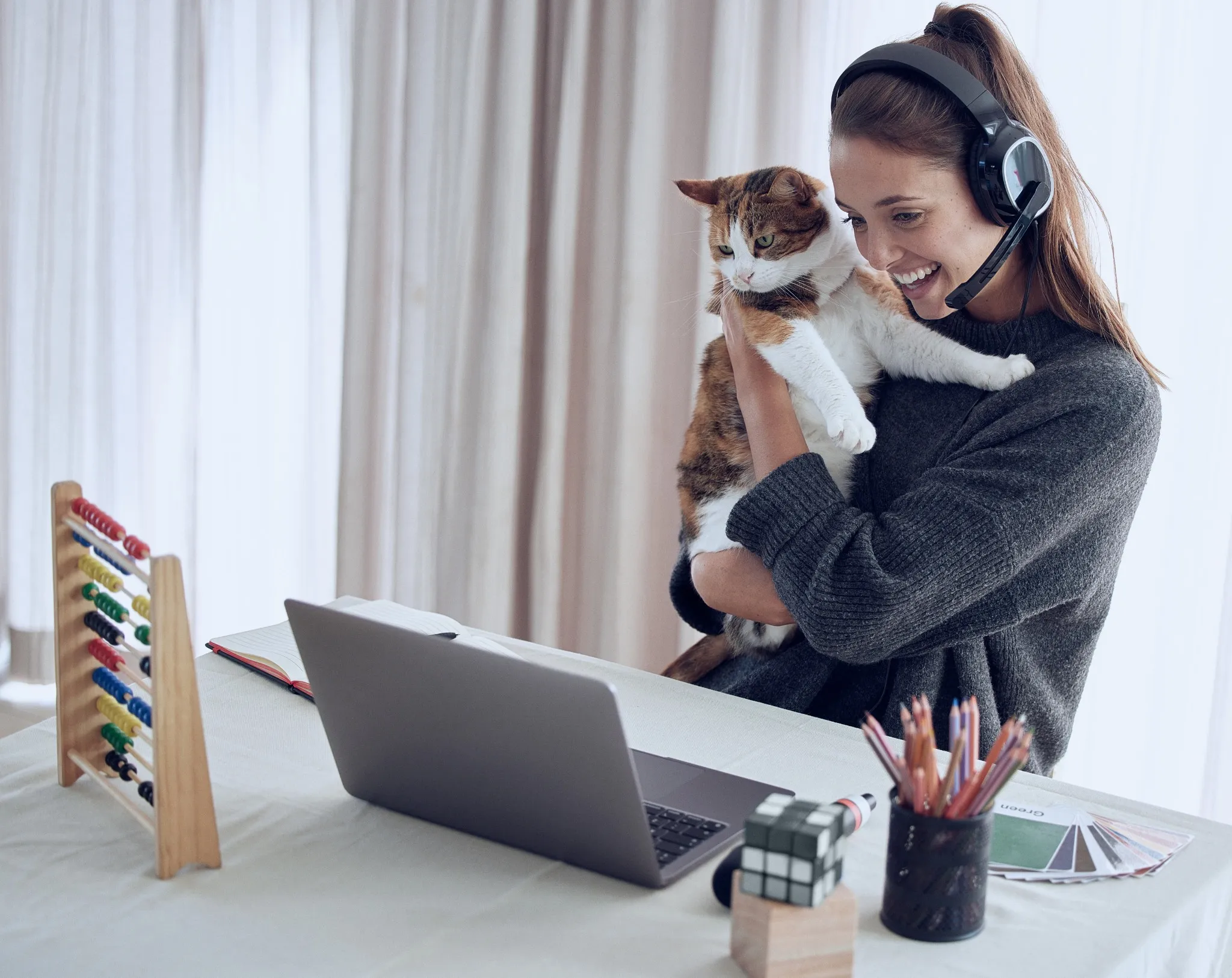 You can never tell where your influence stops. Shot of a young teacher showing her cat to a student online at home..