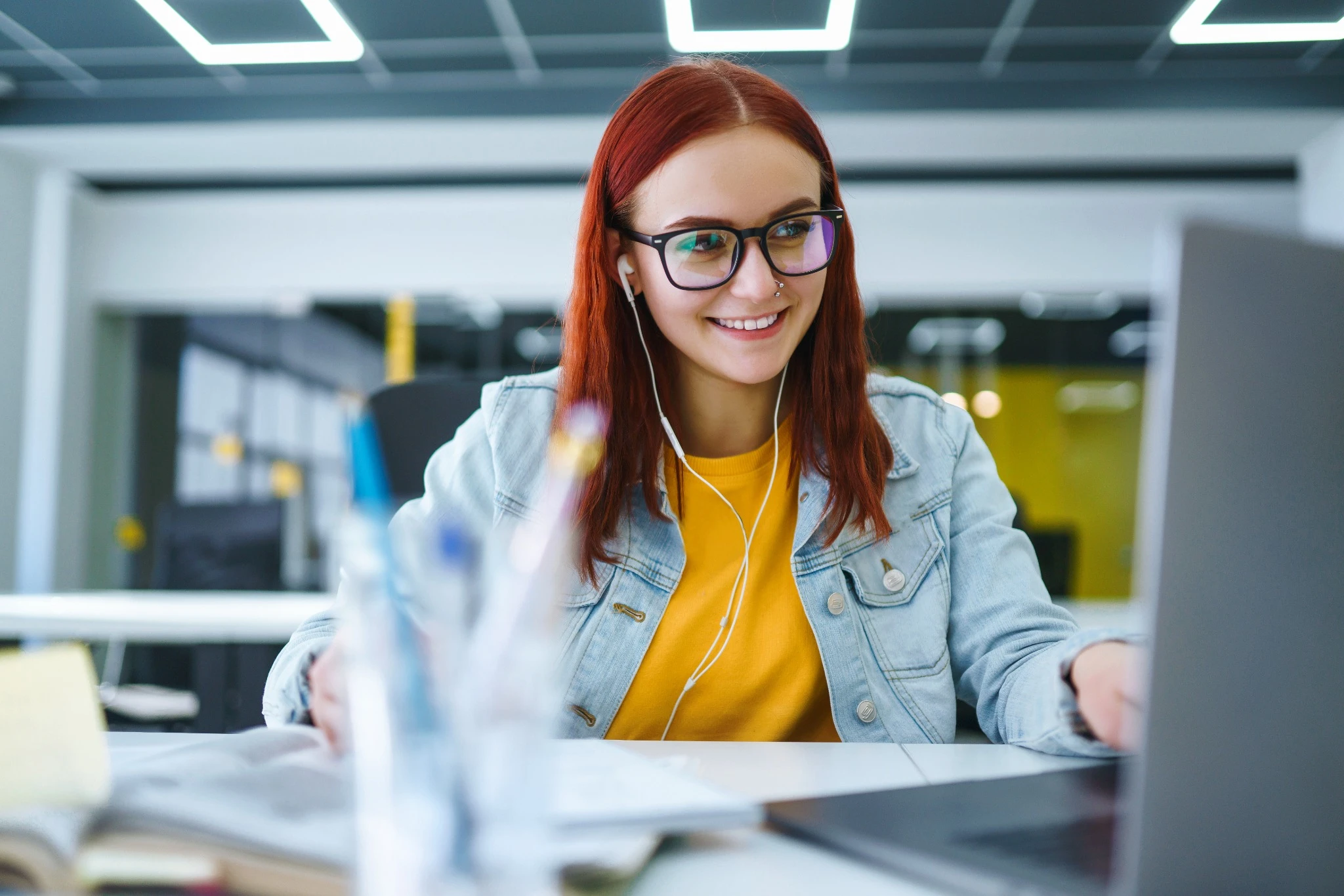 Red hair woman with glasses studying.