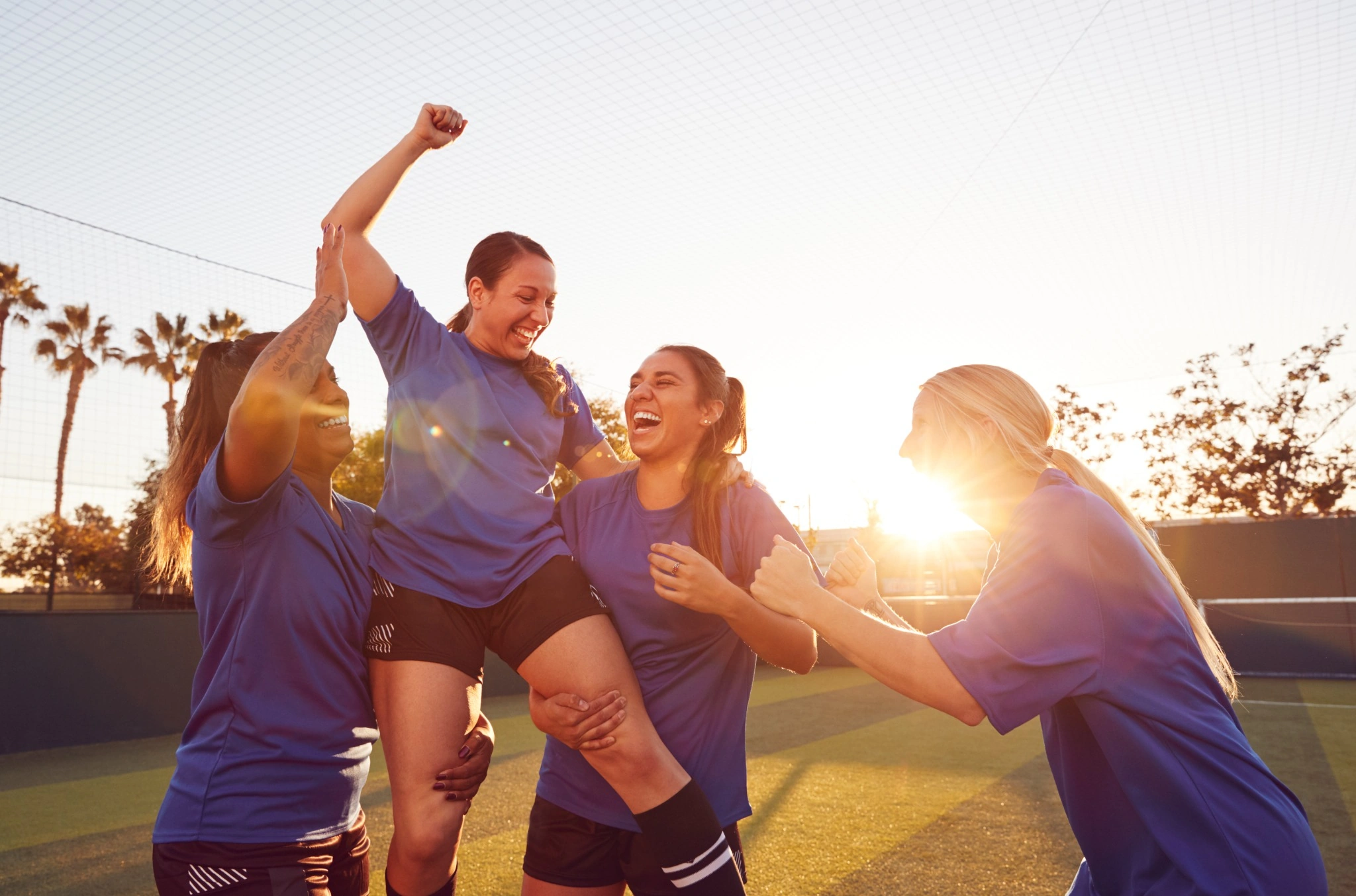 Women soccer players excited and celebrating
