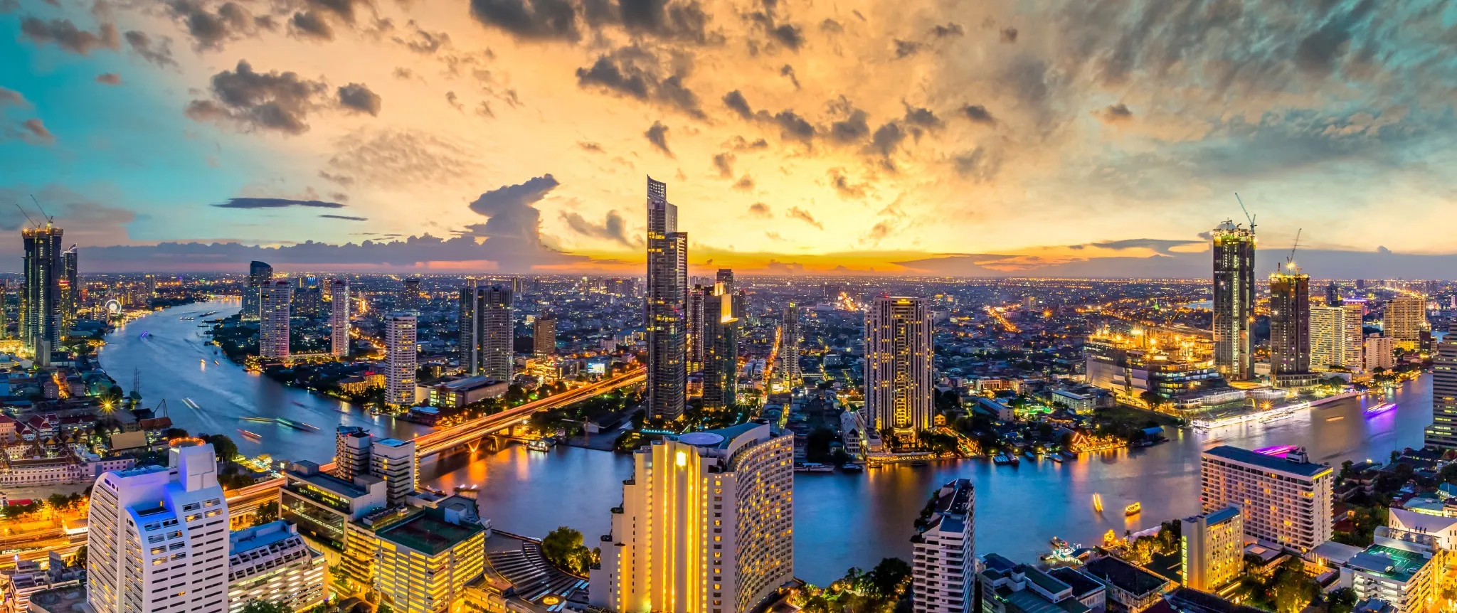 Aerial view Bangkok City skyline and skyscraper on Sathorn Road business and financial in Bangkok downtown, Panorama of Taksin Bridge over Chao Phraya