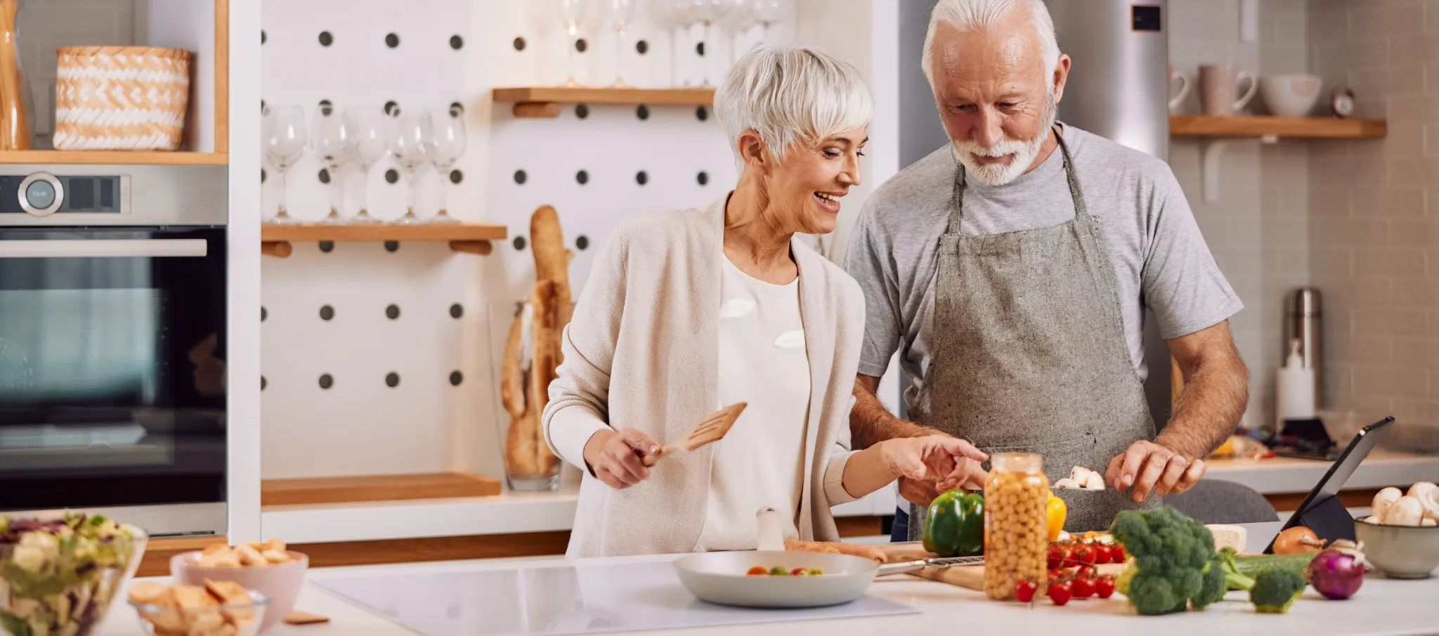 Older couple cooking in kitchen