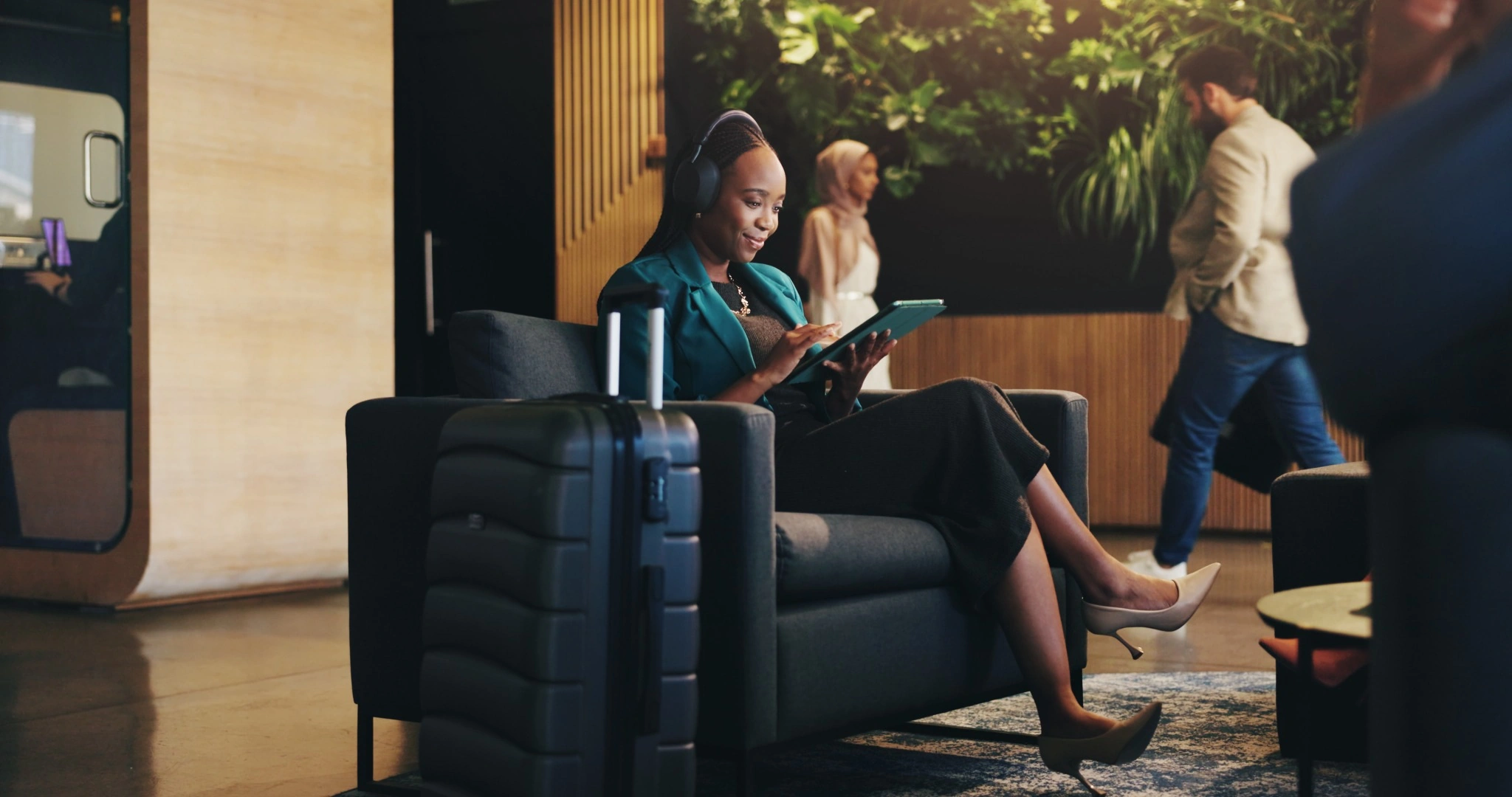 Business professionals discussing a project while using a laptop in an office.