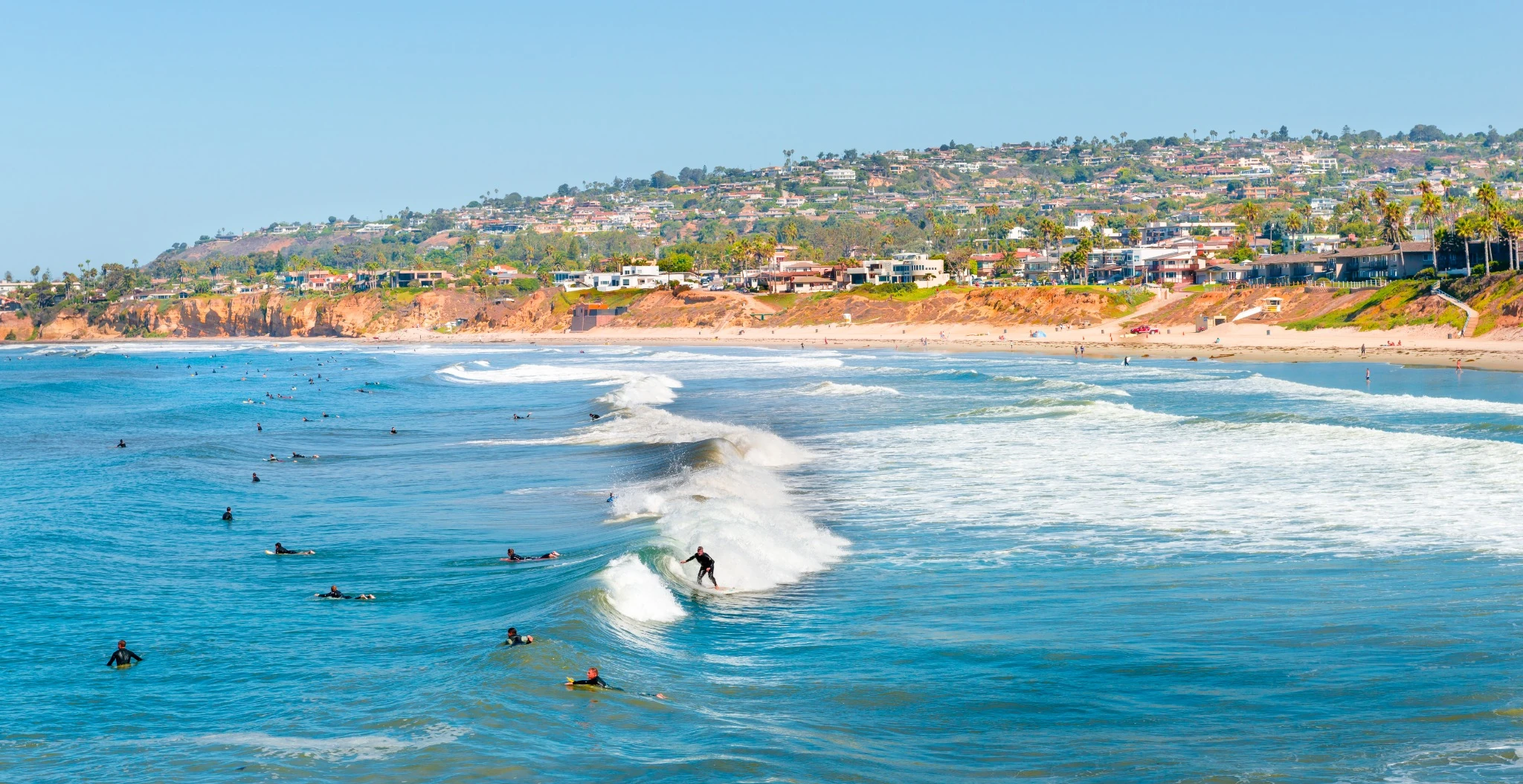 Surfers in the ocean along the coast in Southern California