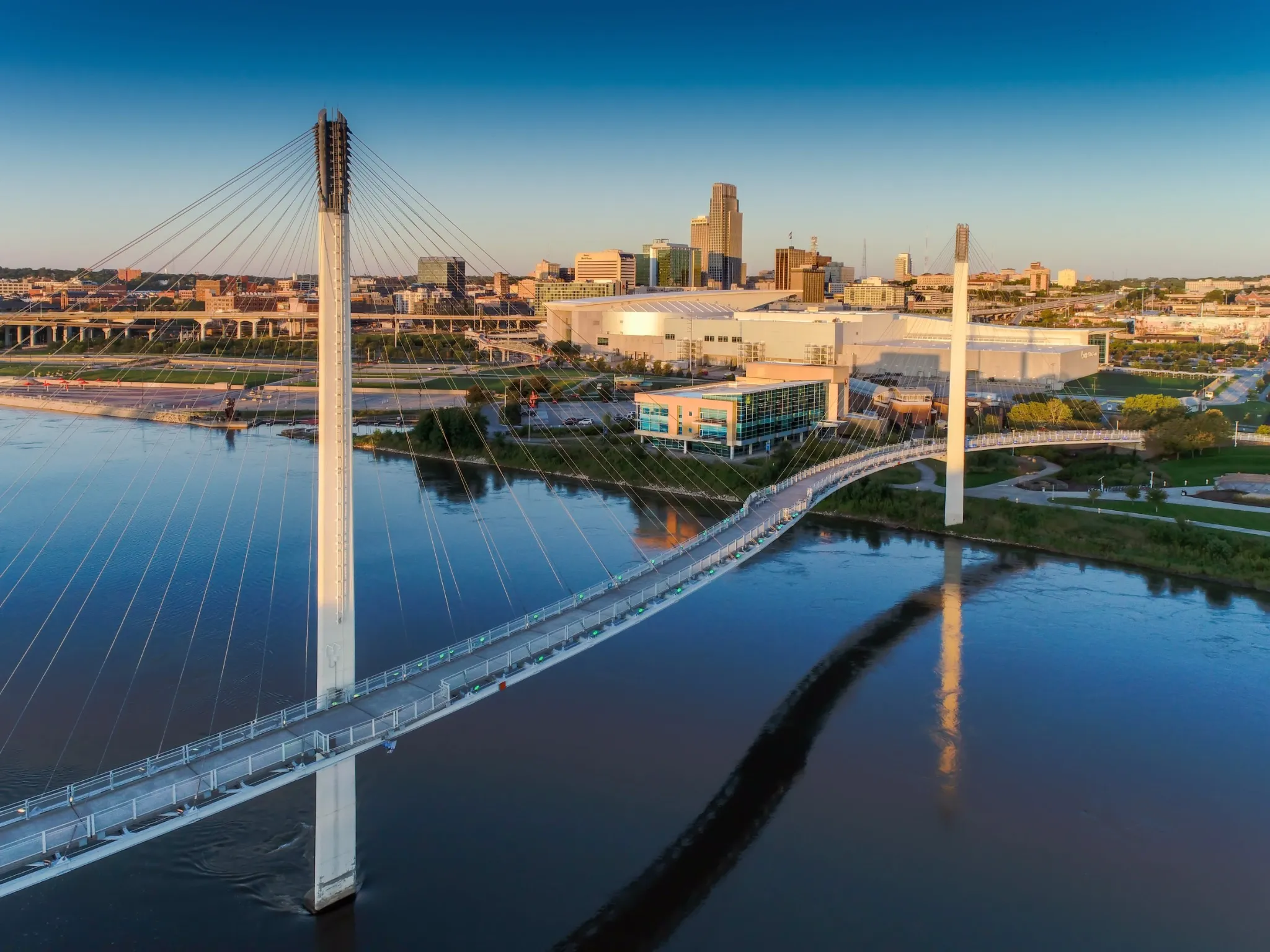 Bob Kerry Pedestrian Bridge spans the Missouri river with the Omaha Nebraska skyline in the background.