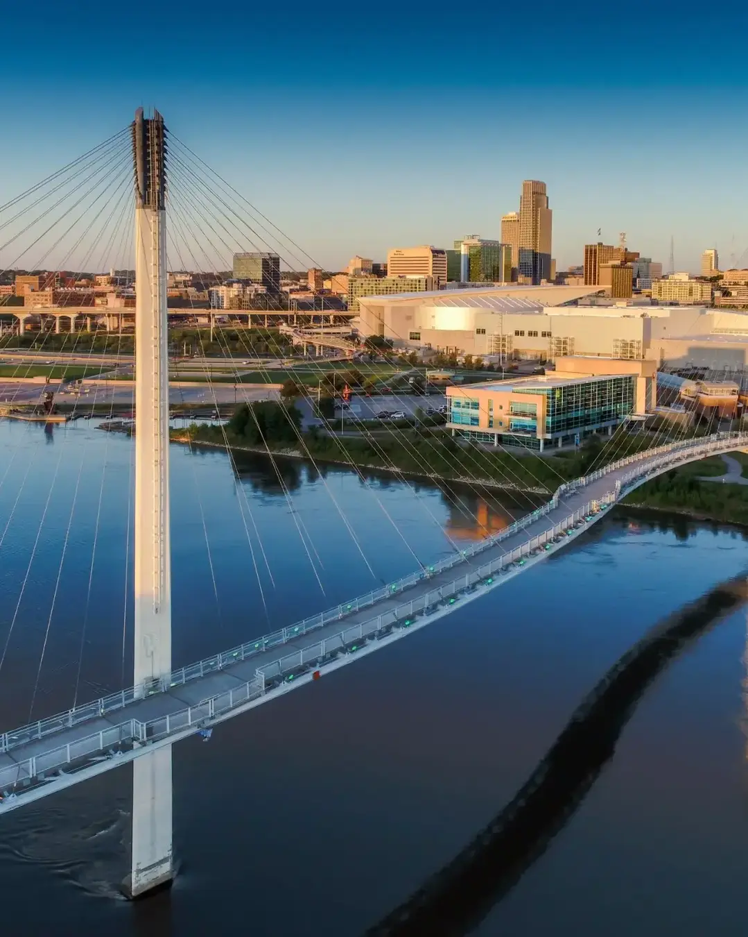 Bob Kerry Pedestrian Bridge spans the Missouri river with the Omaha Nebraska skyline in the background.