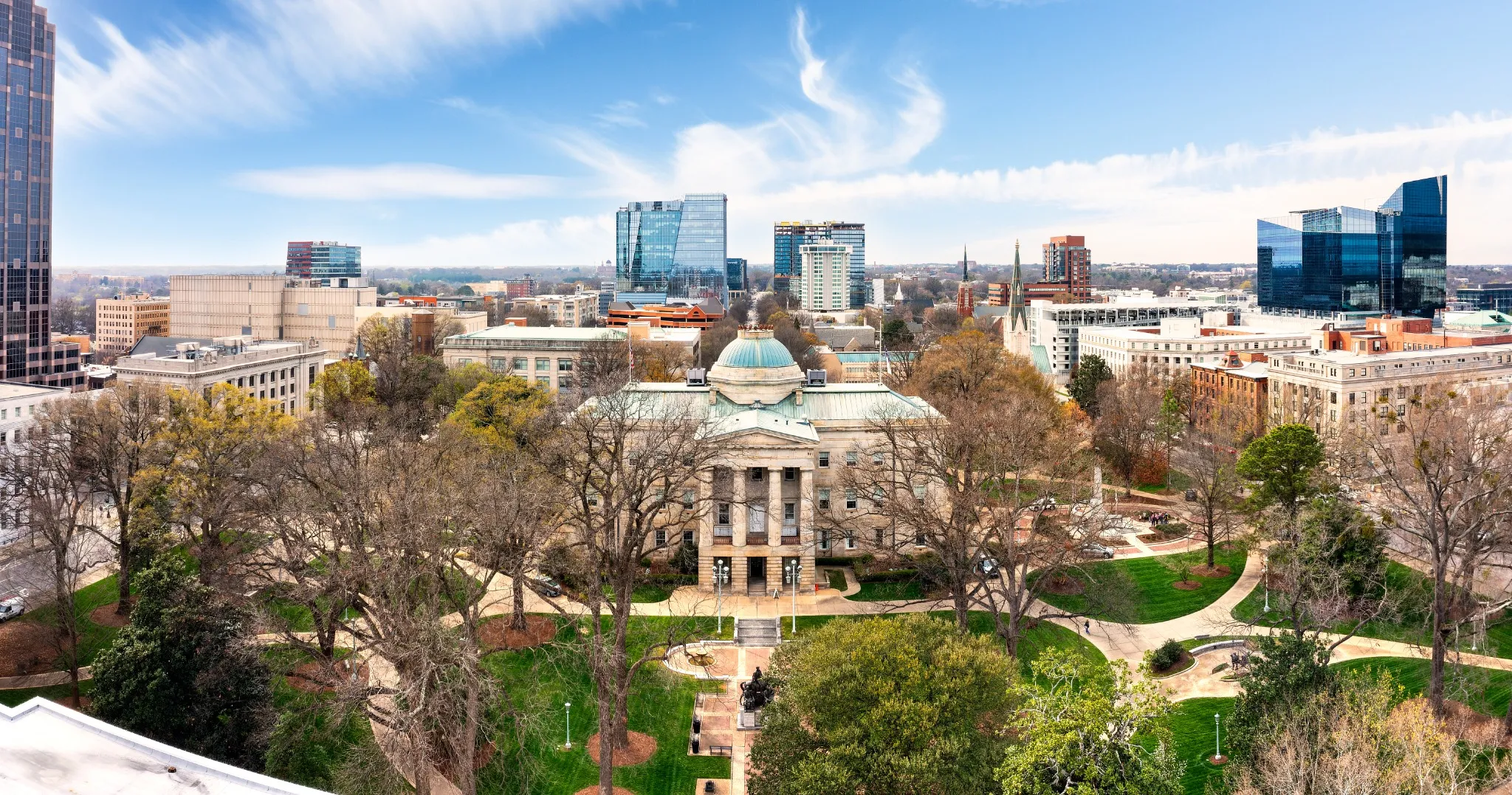 Aerial view of the North Carolina State Capitol and Raleigh skyline