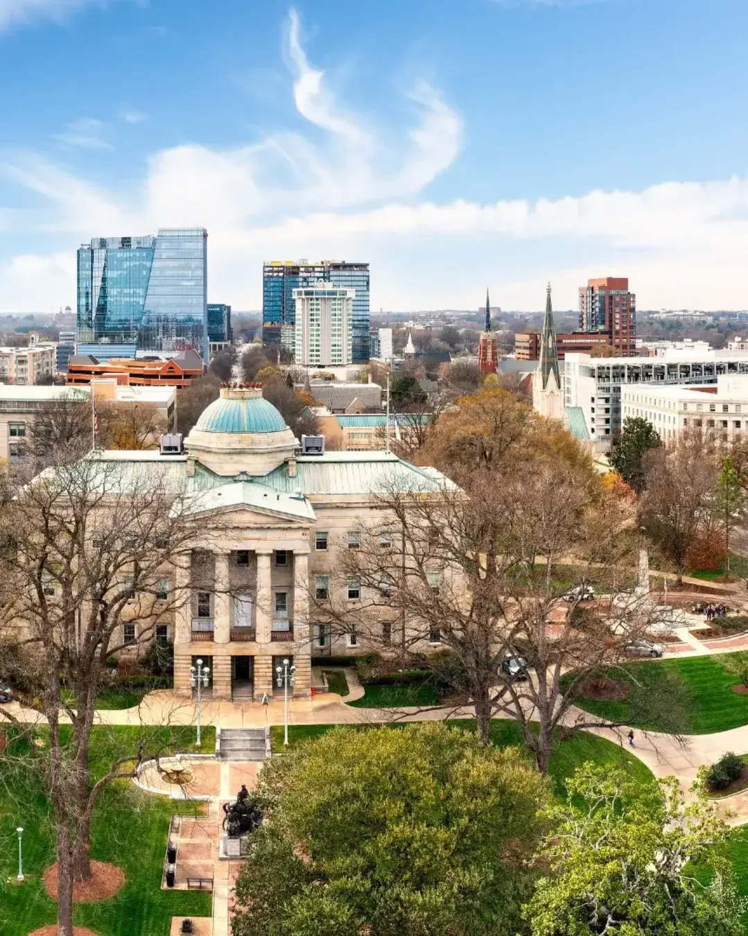 Aerial view of the North Carolina State Capitol and Raleigh skyline