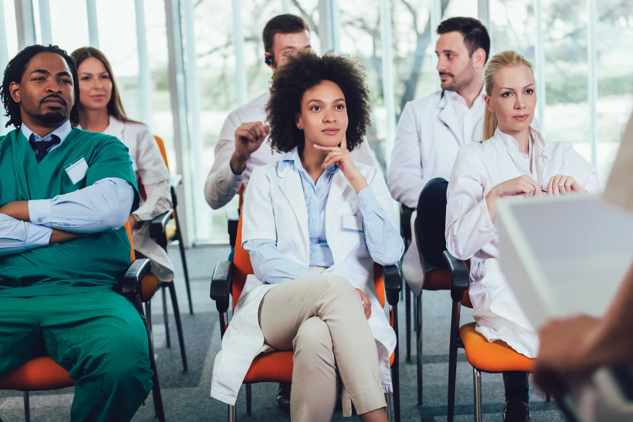 Group of doctors on seminar in lecture hall at hospital.
