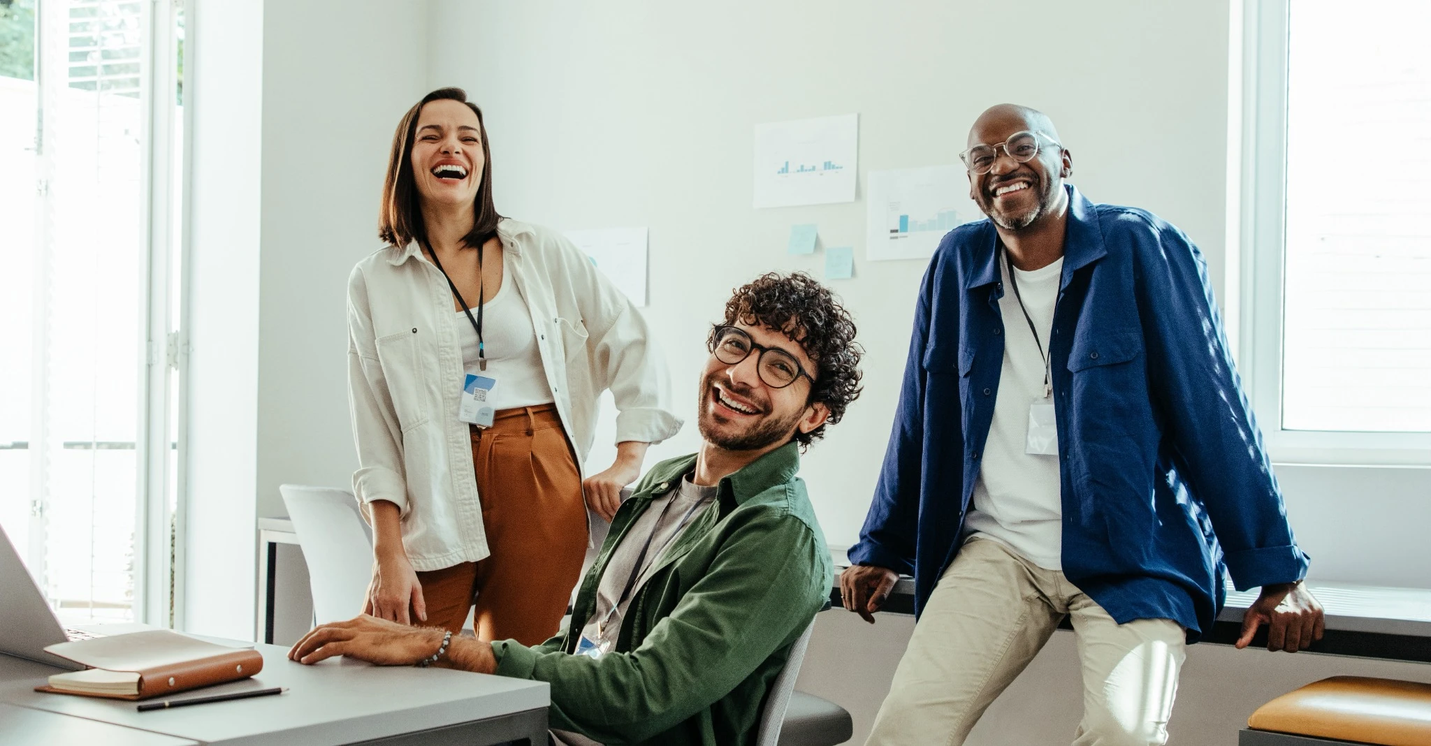 Happy coworkers laughing in someone's office
