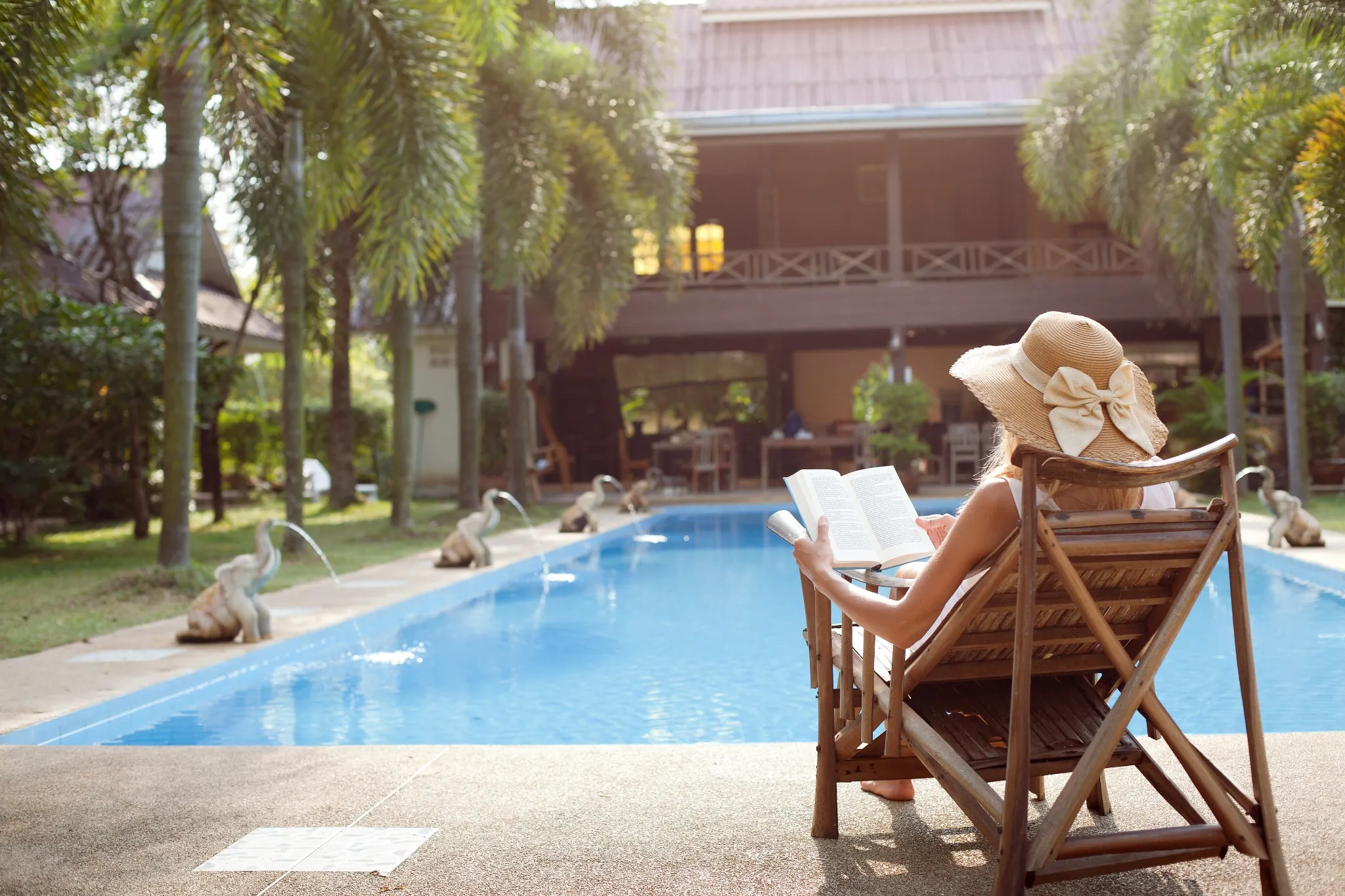 Woman in a deck chair enjoying a book reading