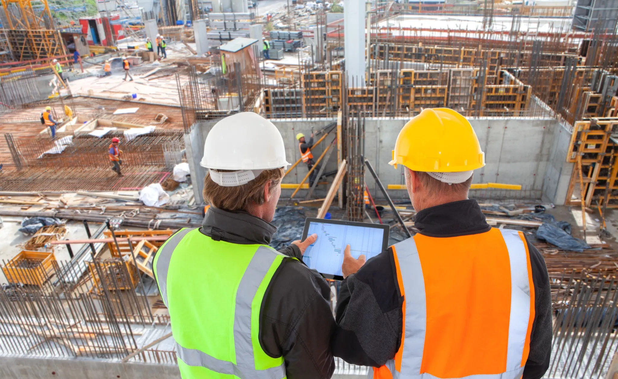 COnstruction workers overlooking large worksite