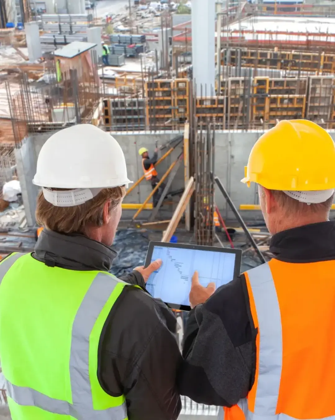 COnstruction workers overlooking large worksite